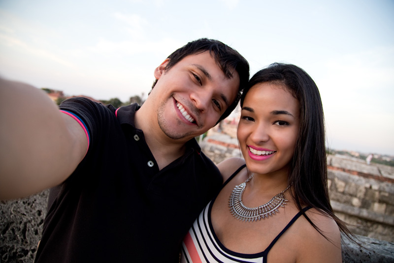 young couple looking at the camera and smiling
